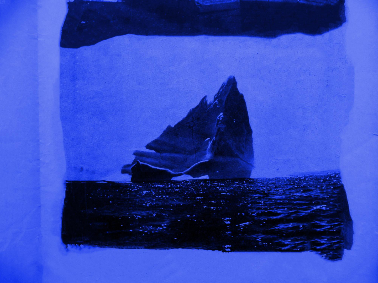 Cyanotype of a rocky island form in blue tones